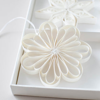 White flower-shaped object on a white background