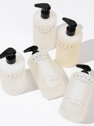 Set of white bottles with black pumps labeled 'Nektar' on a white background