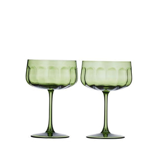 Two green wine glasses on a white background