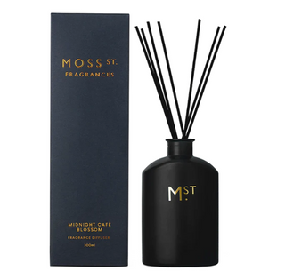 Black fragrance diffuser with sticks and packaging labeled 'Moss St. Fragrances' on a white background.