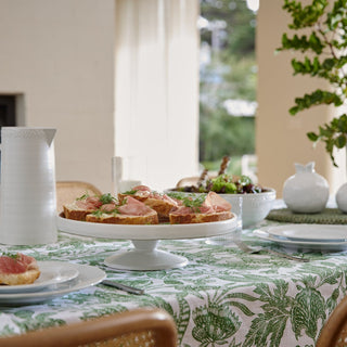Dining table set with appetizers and a floral tablecloth