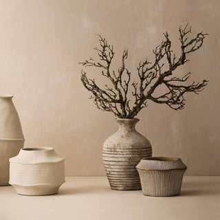 Set of ceramic vases with a branch arrangement on a beige background