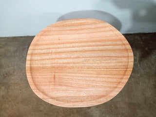 Round wooden stool on a concrete floor